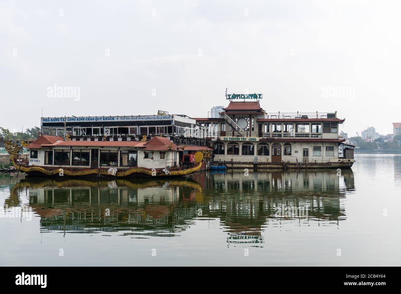 Couple of old abandoned barges on the west lake in Hanoi Stock Photo