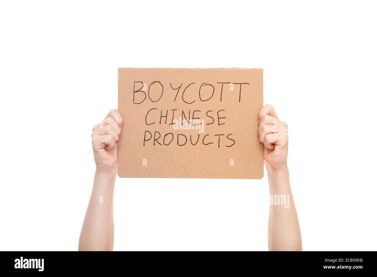 protest poster in the hands of a faceless man with a message to boycott Chinese products, cardboard with manifest text isolated on white background. Stock Photo