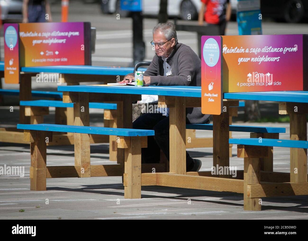 Vancouver, Canada. 10th Aug, 2020. A man sits at the alcohol drinking area at the Vancouver Art Gallery plaza in Vancouver, British Columbia, Canada, Aug. 10, 2020. Vancouver launched a temporary pilot program Monday allowing public consumption of alcohol in select locations. The program aims to encourage people to keep social distance in outdoor space while enjoying drinking, and also to support local food businesses during the COVID-19 pandemic. Credit: Liang Sen/Xinhua/Alamy Live News Stock Photo