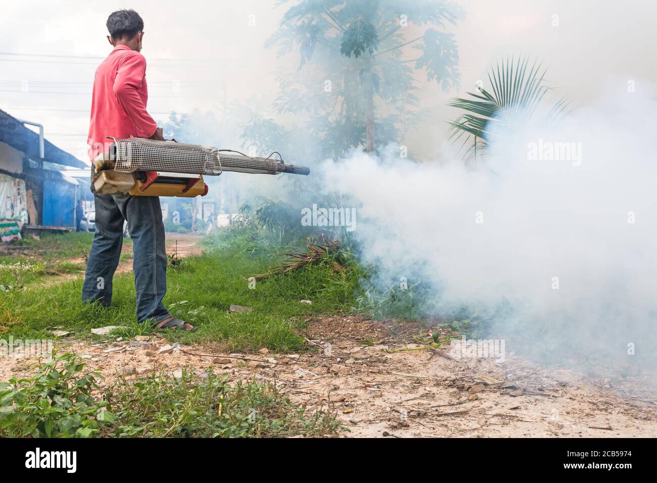 Man Fogging to prevent spread of dengue fever in Thailand Stock Photo