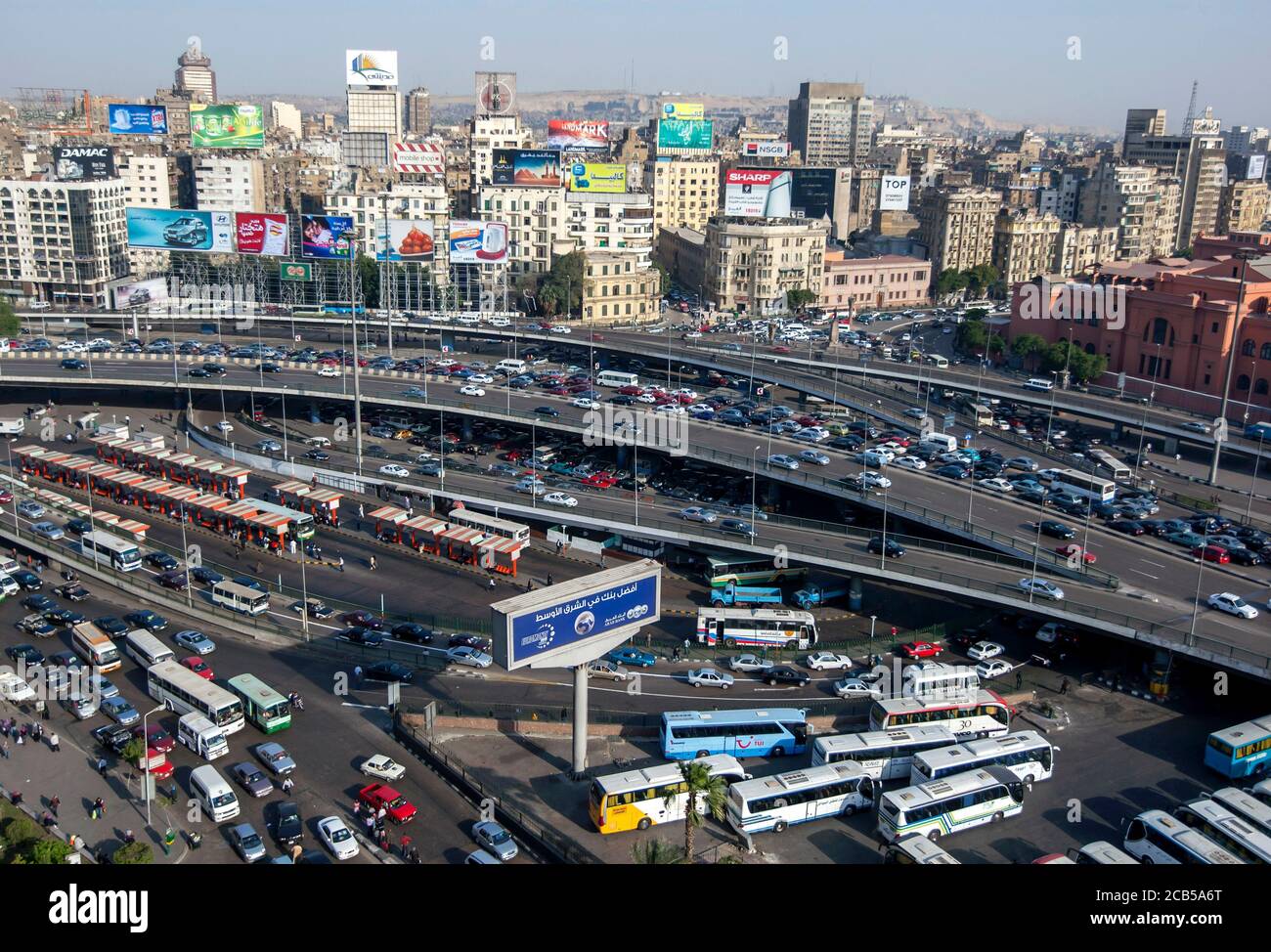 Traffic comes to a crawl on the roads of downtown Cairo in Egypt in the late afternoon. In the background are office buildings and apartments. Stock Photo
