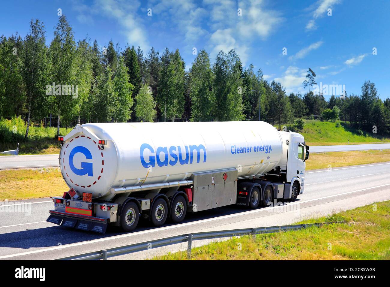 White Scania semi tank truck Gasum hauls LNG, Liquified natural gas, ADR 223-1972, on multiple lane highway in the summer. Salo, Finland. June 12, 20. Stock Photo