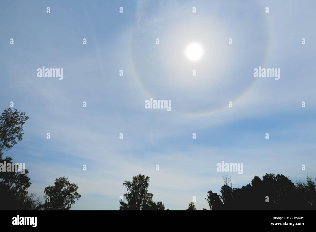 Atmospheric optical effect circle around the sun on hot summer day. Atmospheric halo phenomenon around the sun Stock Photo