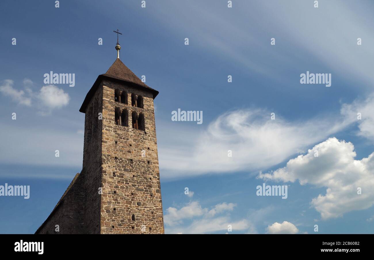 old stone church tower on the dramatic blue clouds background Stock ...