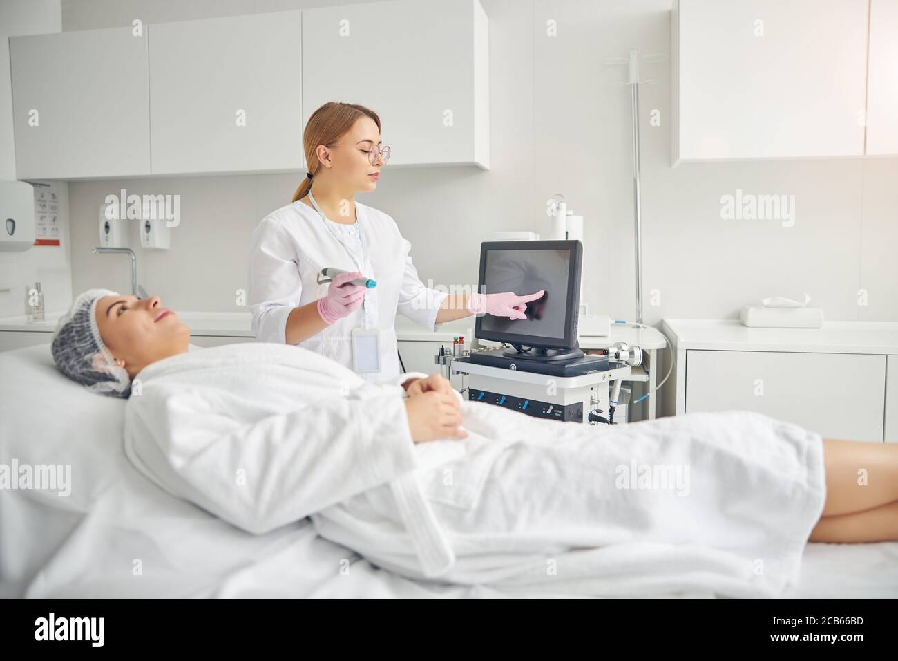 Certified dermatologist preparing her client for a procedure Stock Photo