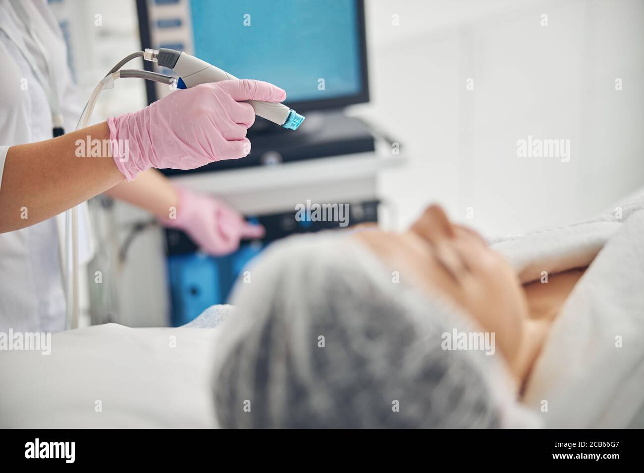 Certified female doctor starting a hydrodermabrasion treatment Stock Photo