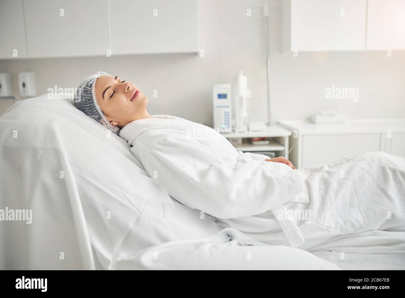Calm spa client relaxing before a cosmetic procedure Stock Photo