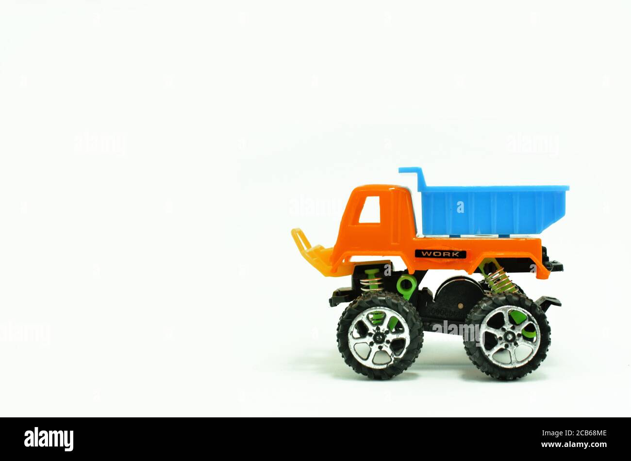 Plastic dump truck toy construction vehicle isolated on white background Stock Photo