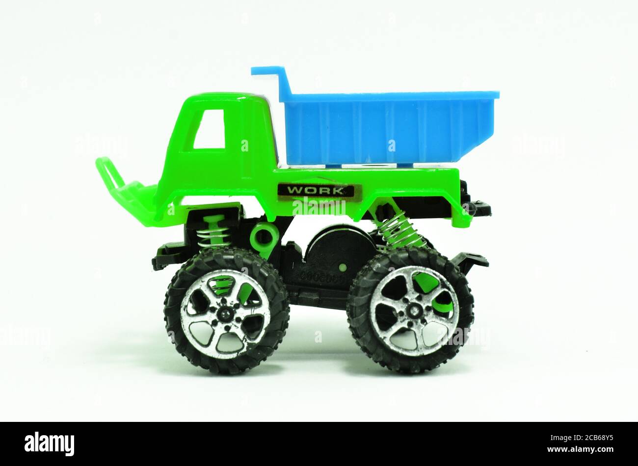 Plastic dump truck toy construction vehicle isolated on white background Stock Photo