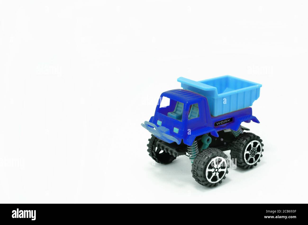 Plastic dump truck toy construction vehicle isolated on white background Stock Photo