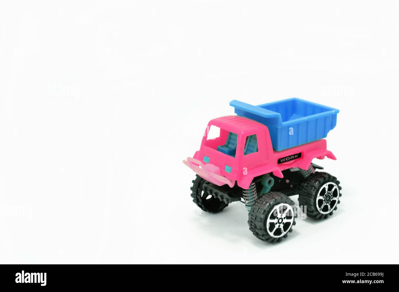 Plastic dump truck toy construction vehicle isolated on white background Stock Photo