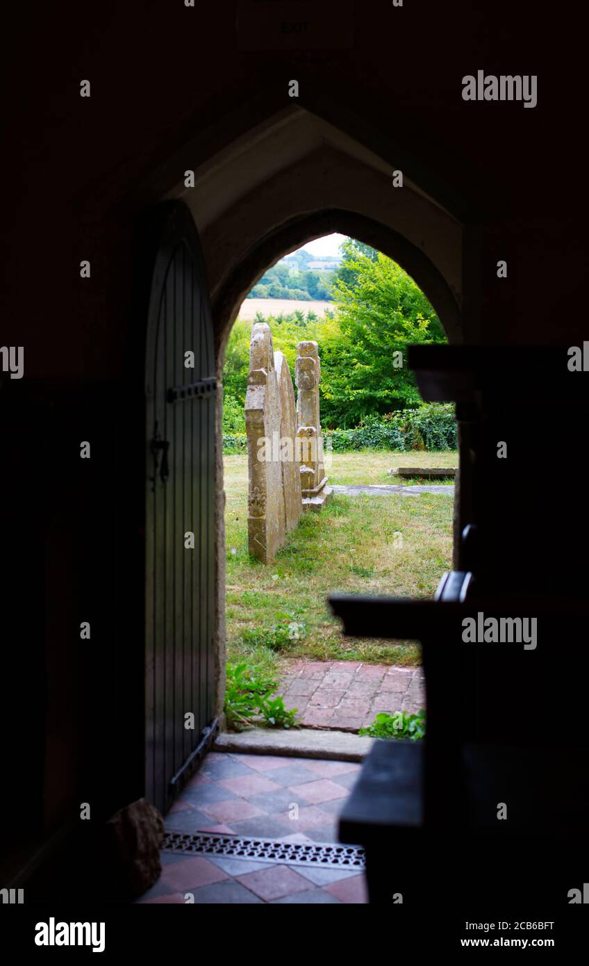 archway from a church looking onto graveyard Stock Photo
