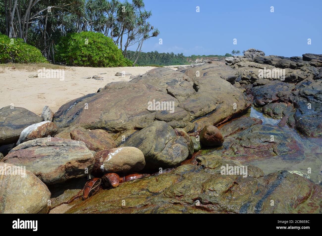 Beautiful scenery of rock formations on the beach with splashing sea ...