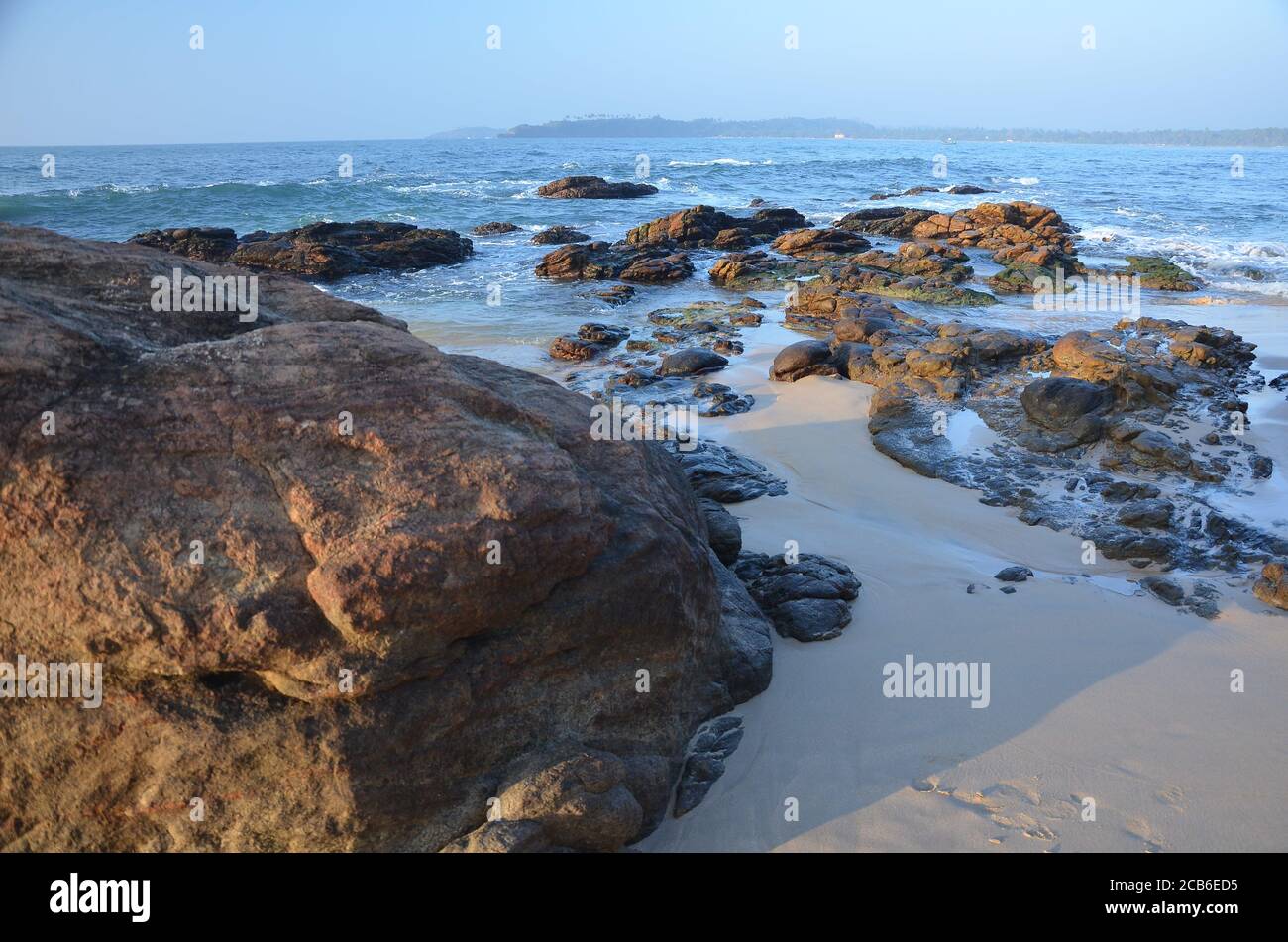 Beautiful scenery of rock formations on the beach with splashing sea ...