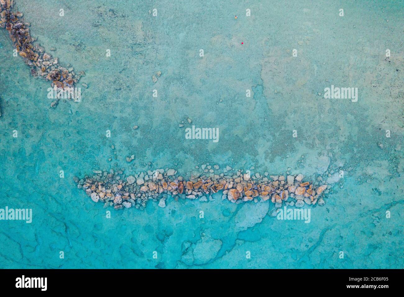 Clear Sea Rocks Aerial view of clear blue sea with rocks Stock Photo - Alamy