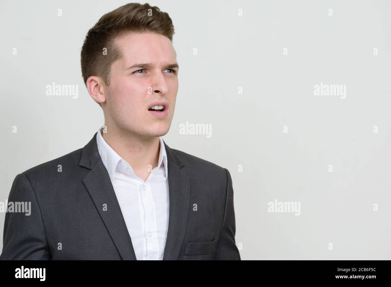 Portrait of young handsome businessman in suit Stock Photo - Alamy