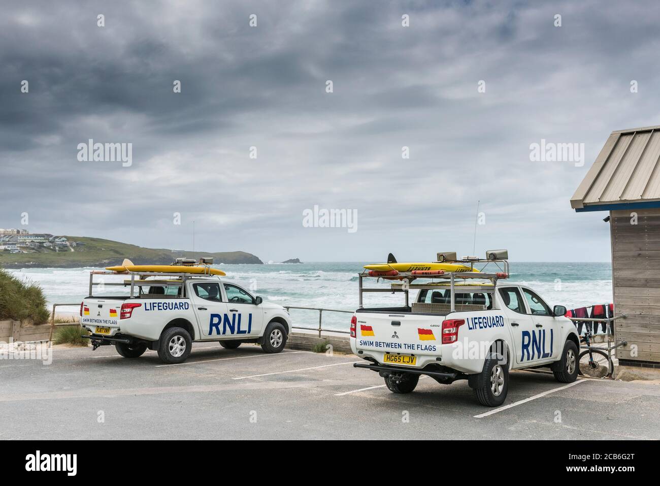 Two RNLI Emergency response vehicles parked in a car park overlooking Fistral Beach in Newquay in Cornwall. Stock Photo