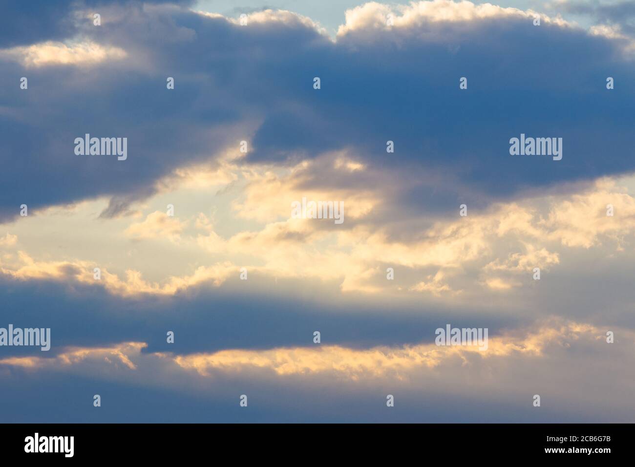 cloudy sky in yellow light. natural background at sunrise. inspiring scene Stock Photo