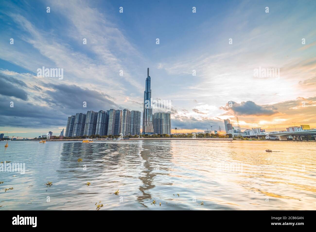 Sunset at Landmark 81 is a super tall skyscraper in center Ho Chi Minh City, Vietnam and Saigon bridge with development buildings, energy power infras Stock Photo