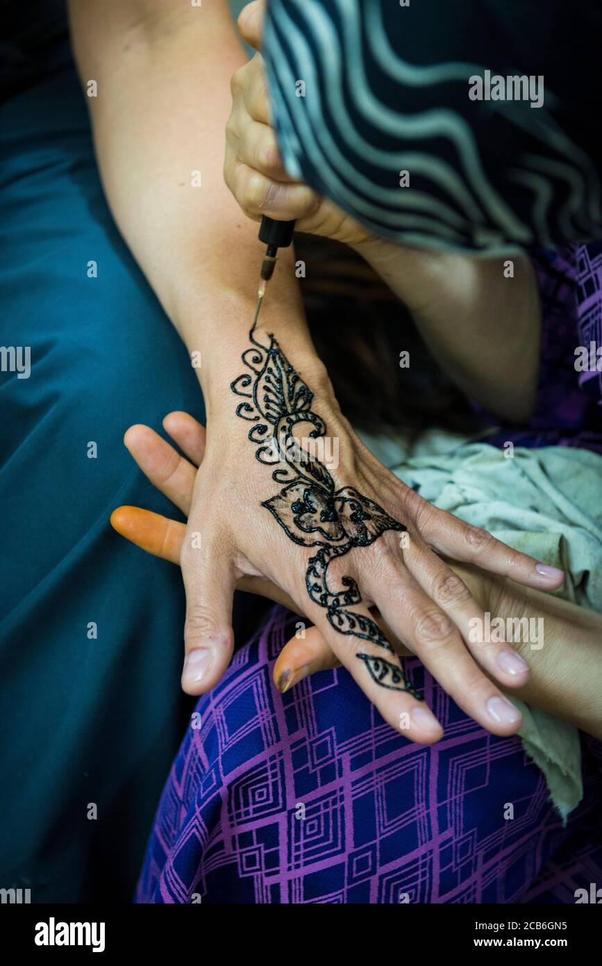 Fes, Marocco, North Africa. Henna tattoo on hand for a tourist. Stock Photo