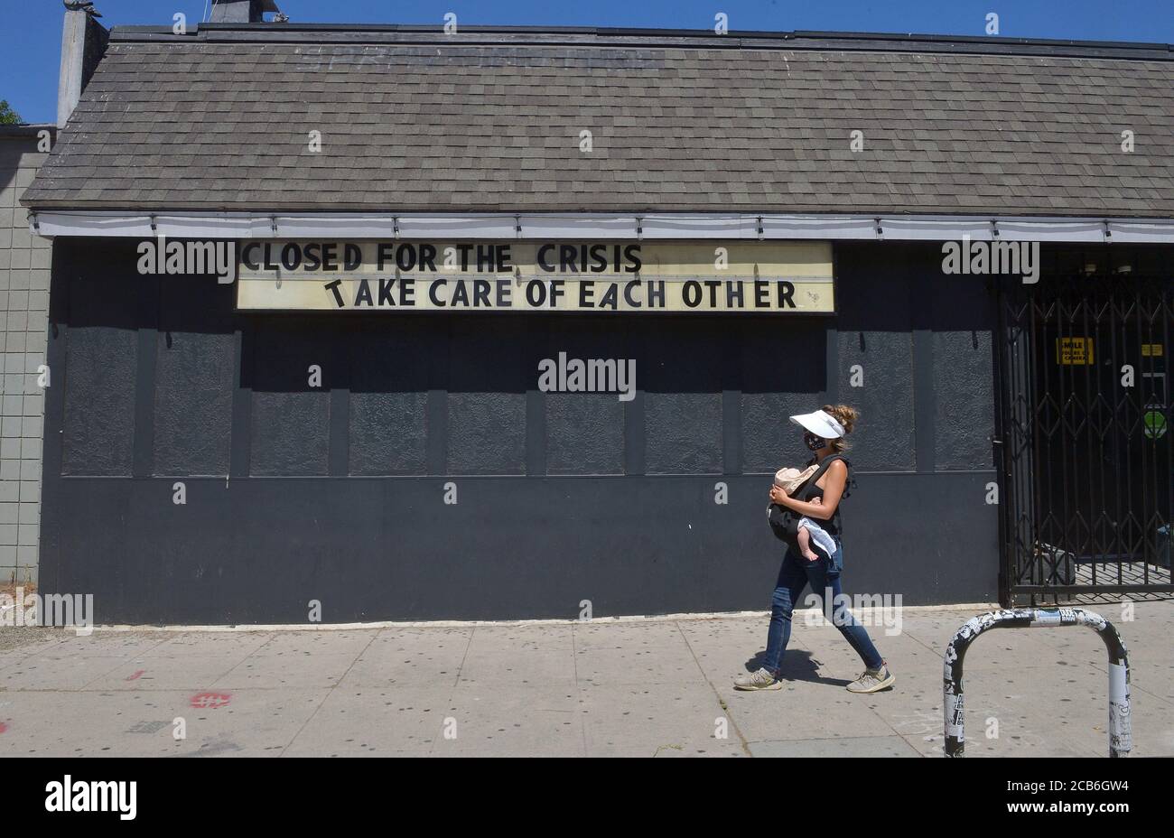 Los Angeles, United. 10th Aug, 2020. A woman walks past a bar closed for the second time by Los Angeles County officials following a spike in COVID-19 cases in the Silver Lake area of Los Angeles on Monday, August 10, 2020. 'We're cautiously optimistic that we're getting back on track to slowing the spread of COVID-19,' said county Public Health Director, Dr. Barbara Ferrer, who added, 'I want to emphasize the word 'cautiously.'' Photo by Jim Ruymen/UPI Credit: UPI/Alamy Live News Stock Photo