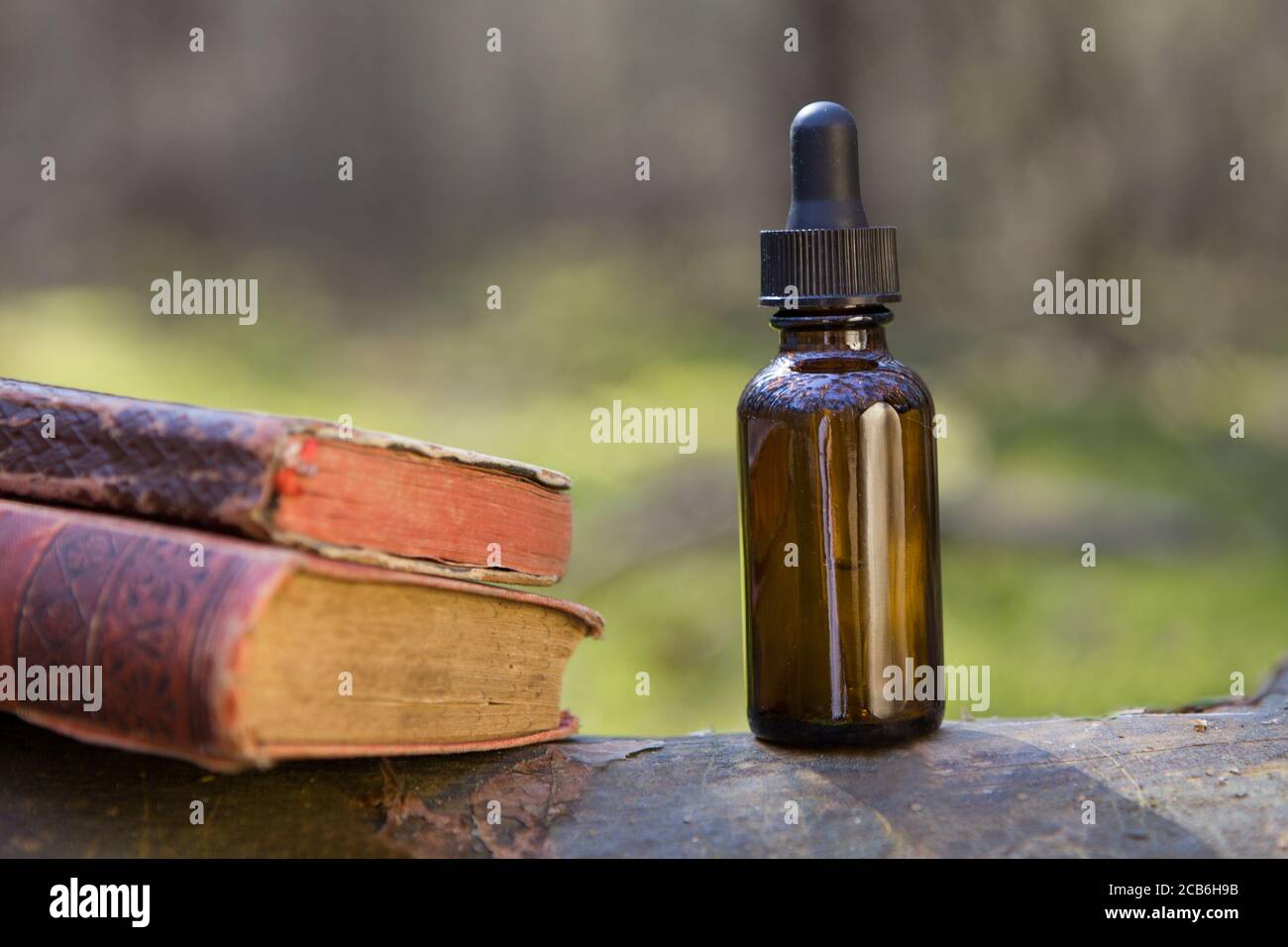 Natural apothecary with essential oils and book on science sheet Stock