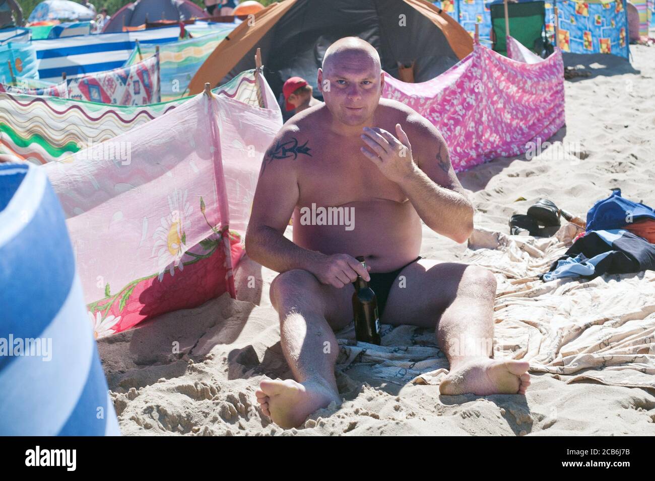 Poland, Wladyslawowo in Pomeranian province 14.08.2015. The man drinking the beer on the beach. Photo CTK/Grzegorz Klatka. Stock Photo