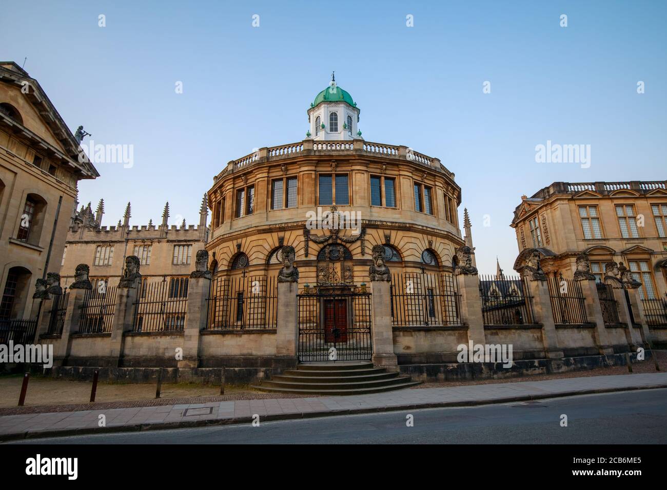 The Sheldonian Theatre and the statues around it, from Broad Street in Oxford with no people. Early in the morning. Oxford, England, UK. Stock Photo