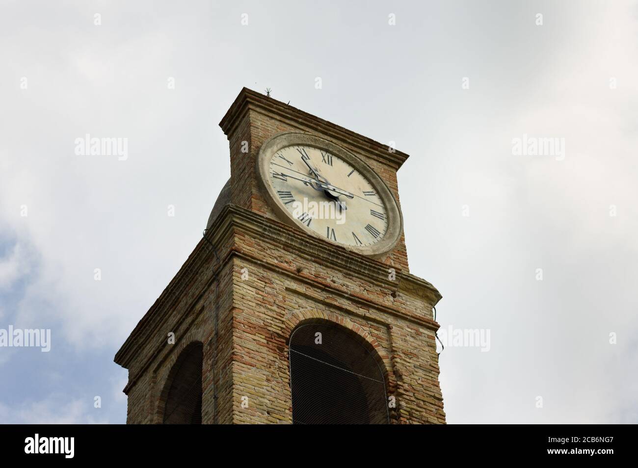 A medieval bell and clock tower of an ancient church (Pesaro, Italy, Europe) Stock Photo