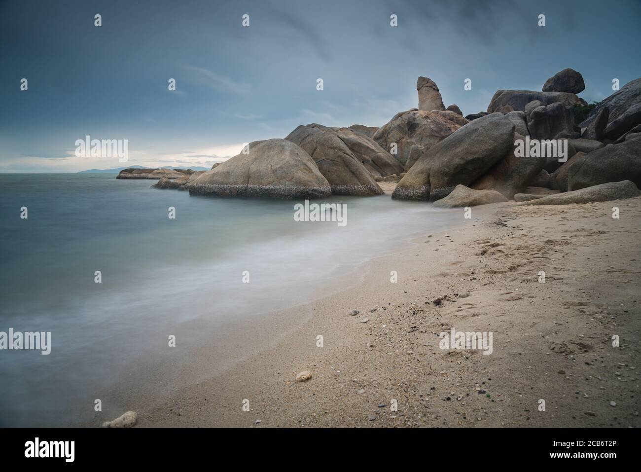 The scenery of the long-exposure of Hinta or Grandfather (Grandpa) rocks of Lamai beach in Samui island, Surat Thani, Thailand. Stock Photo