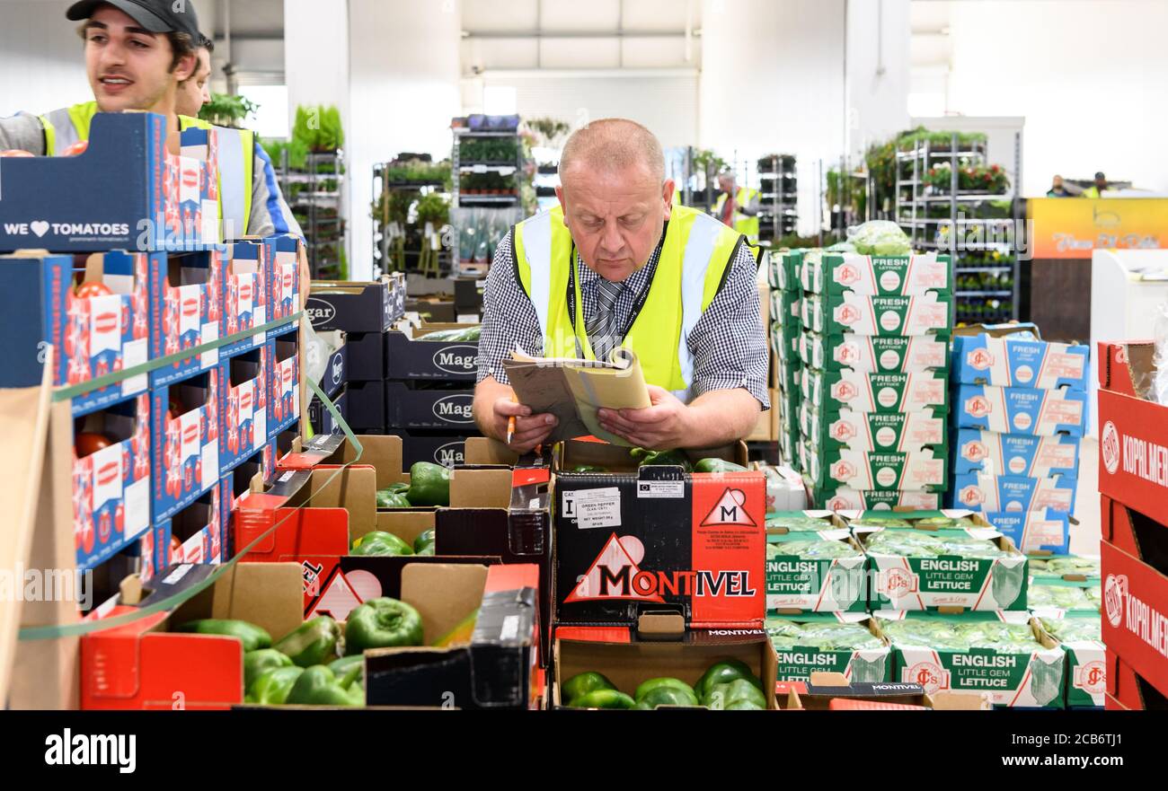 Staff and customers at the Birmingham Wholesale Market. The largest integrated market in the UK providing fruit and vegetable, fish, poultry, meat and flower trading operations on one site. The current premises opened in May 2018. Stock Photo
