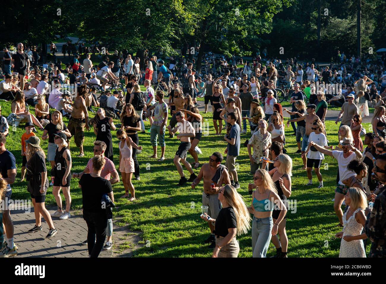 People dancing to techno music at Teknopicnic open-air dance party in Alppipuisto Park in Helsinki, Finland Stock Photo
