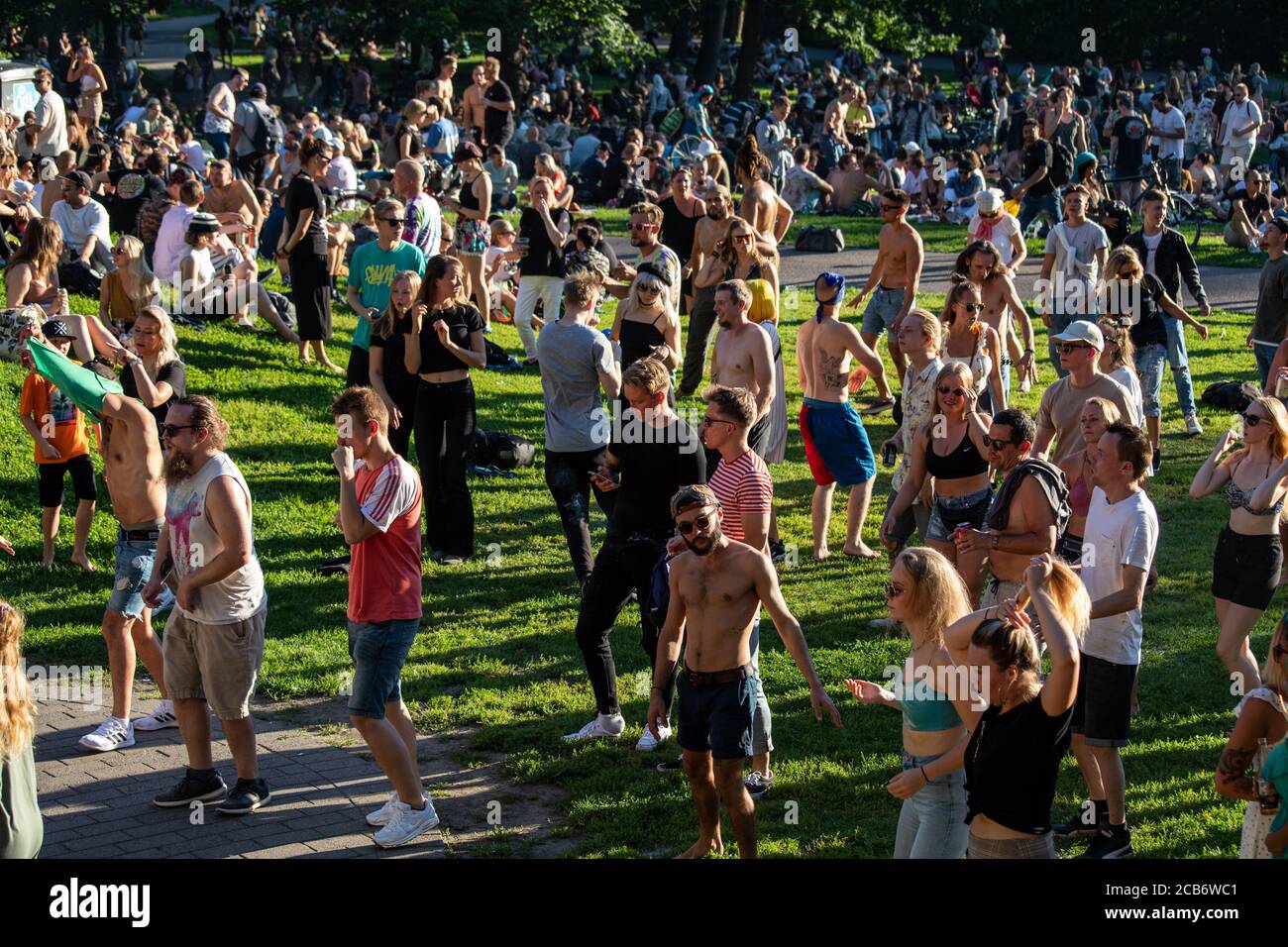 People dancing at Teknopicnic free open air techno dance party in Alppipuisto Park, Helsinki, Finland Stock Photo