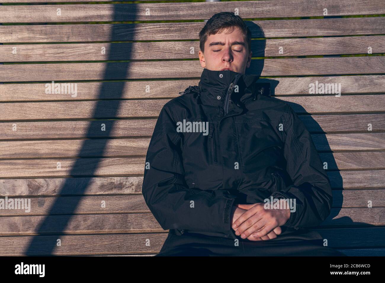 Man sunbathing on bench hi-res stock photography and images - Alamy