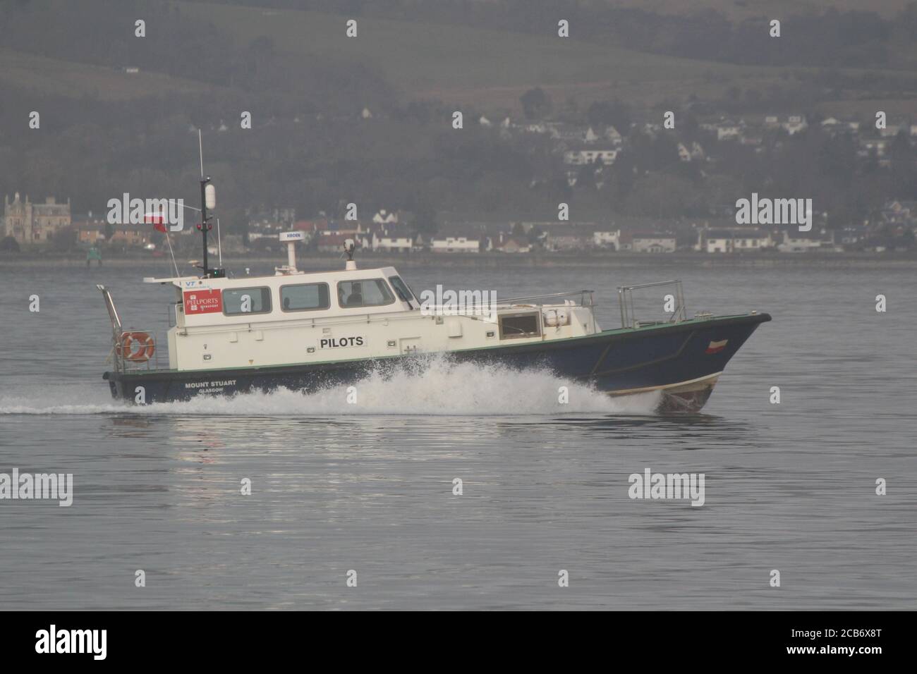 Mount Stuart, a pilot boat operated by Peelports (Clydeport) on the Firth of Clyde, speeding past Greenock Esplanade during a slightly misty day. Stock Photo