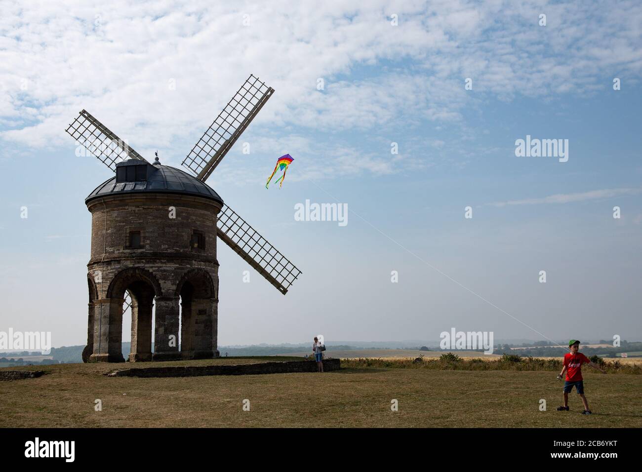 Jack, 10, plays with his kite as he enjoys the hot weather by Chesterton Windmill, Warwickshire. Stock Photo