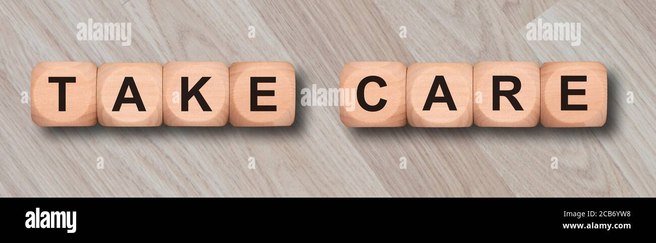 take care printed on wooden cubes Stock Photo