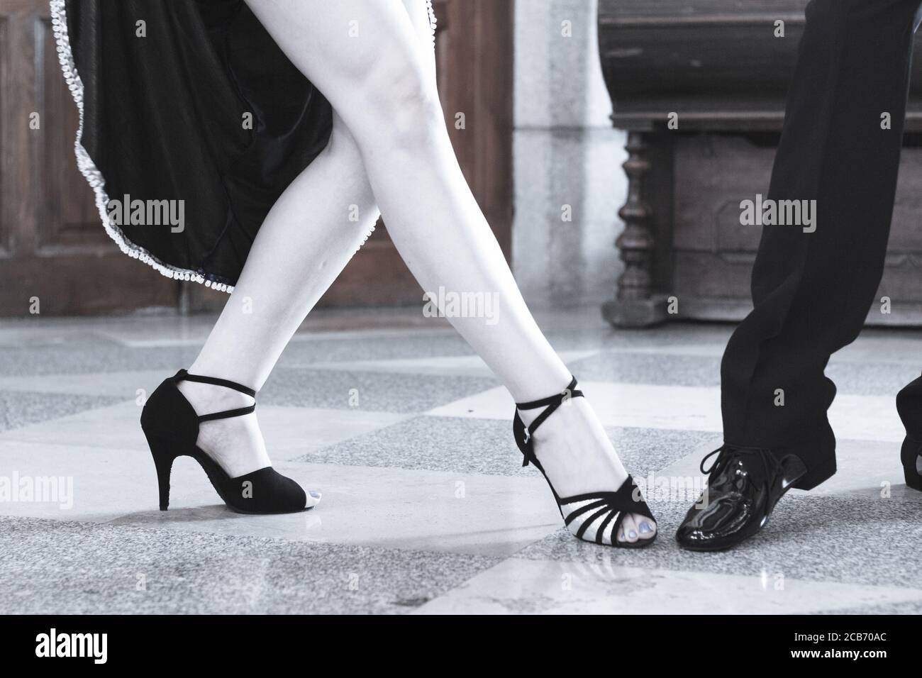 Legs of man and woman dancing Argentine tango. Black shoes Stock Photo -  Alamy