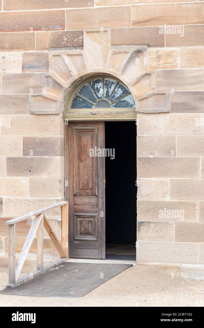The entrance to one of the convict built, cut sandstone buildings with ornate detailing on Cockatoo Island Dockyard in Sydney Harbour, Australia Stock Photo