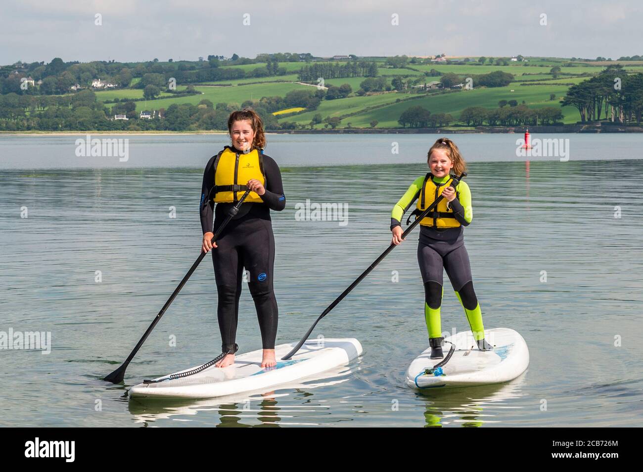 Courtmacsherry, West Cork, Ireland. 11th July, 2020. On yet another day of very warm sunshine, many people headed to the beach. Doing a spot of paddle boarding were Aoibheann and Caoimhe Byrne on holiday from Co. Cavan. Credit: AG News/Alamy Live News Stock Photo