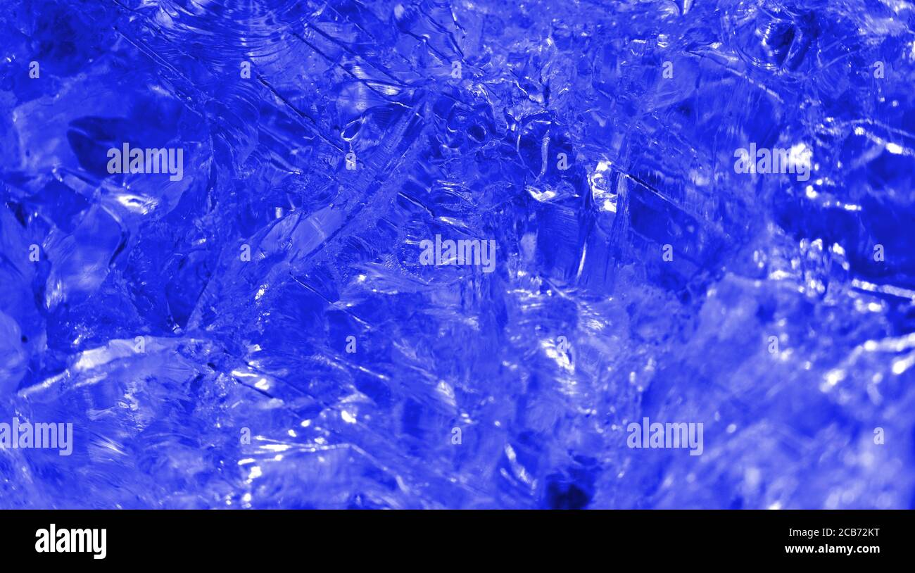 Isolated macro abstract of the surface of a clear quartz rock filtered to appear as a frozen piece of cold blue ice crystal Stock Photo