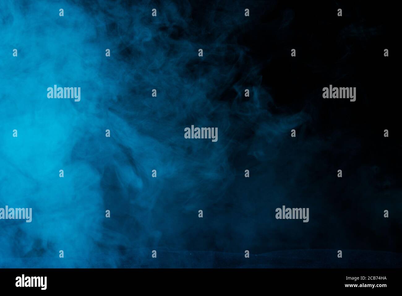 mysterious and bright cloud of blue steam on a dark background concept ...