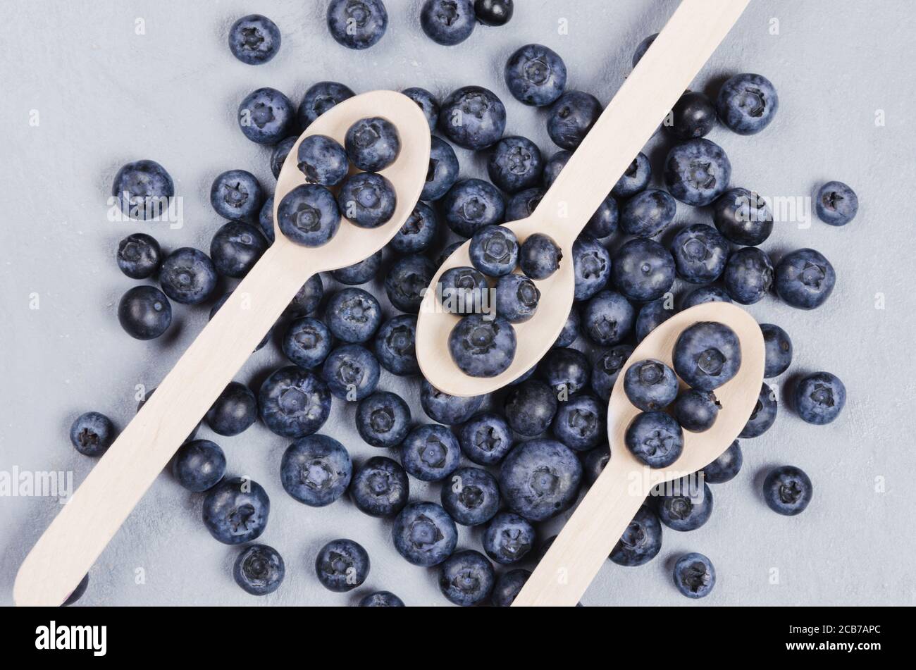 Close up bog bilberries on a wooden spoons. Healthy nutrition concept Stock Photo