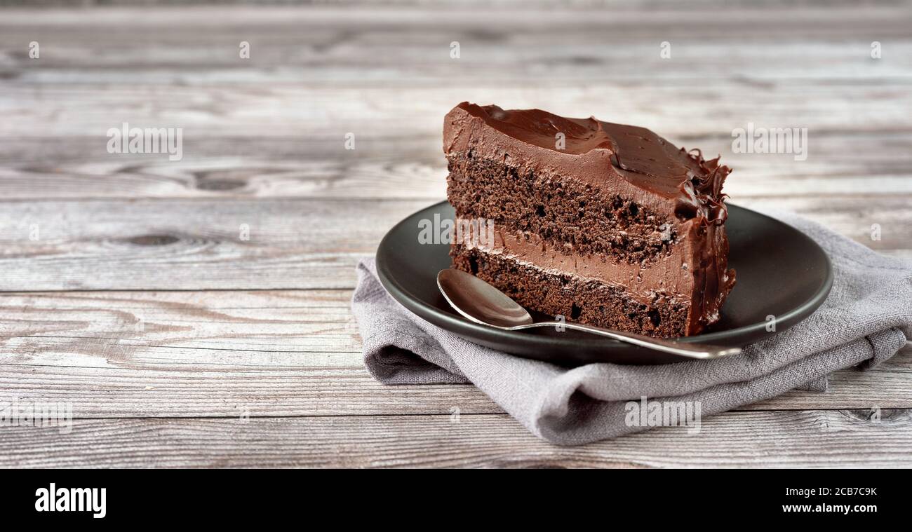 A peace of vegan chocolate davil cake on grey wooden background Stock Photo