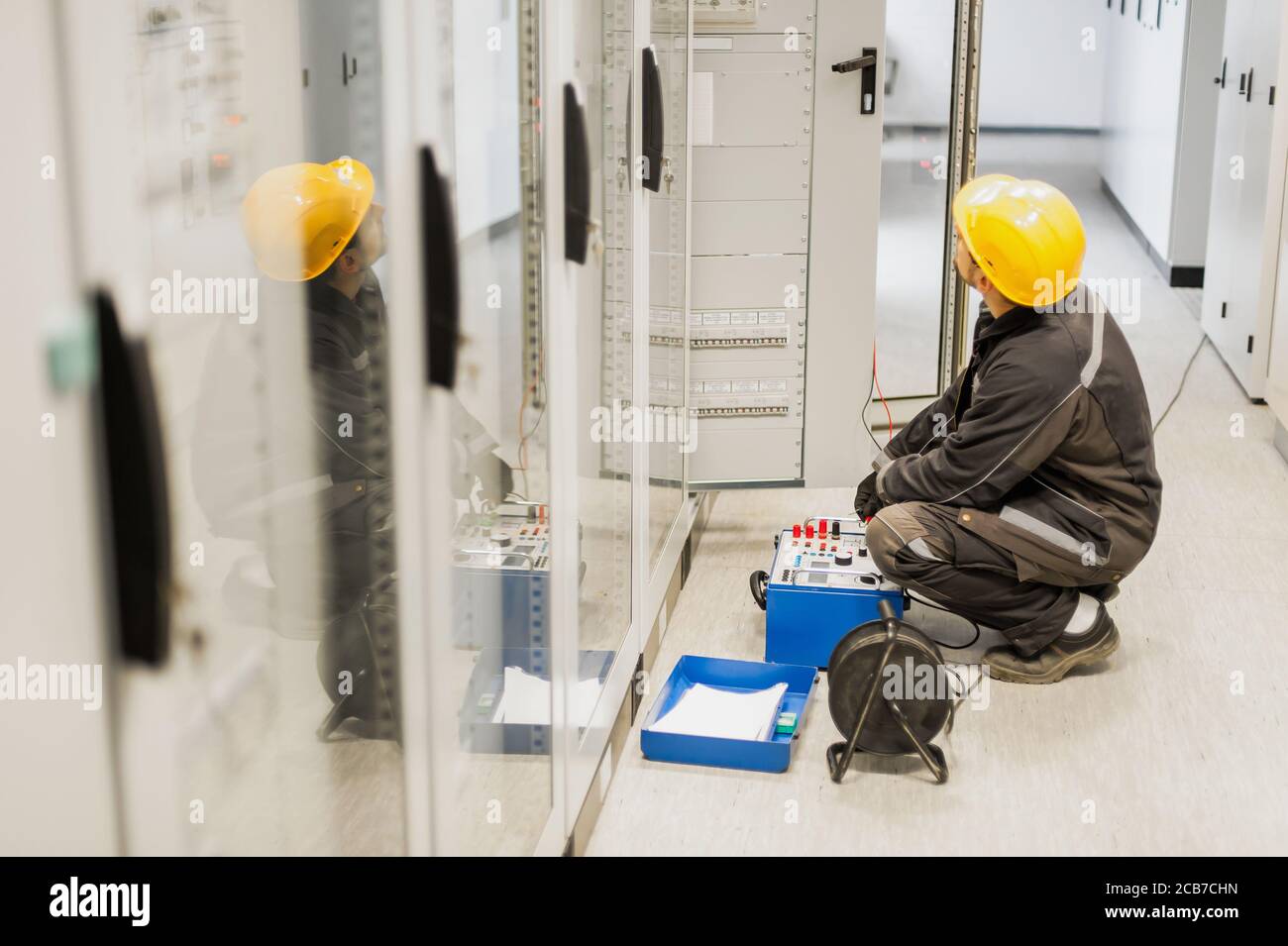 Electrician engineer tests system with relay test set equipment. Relay
