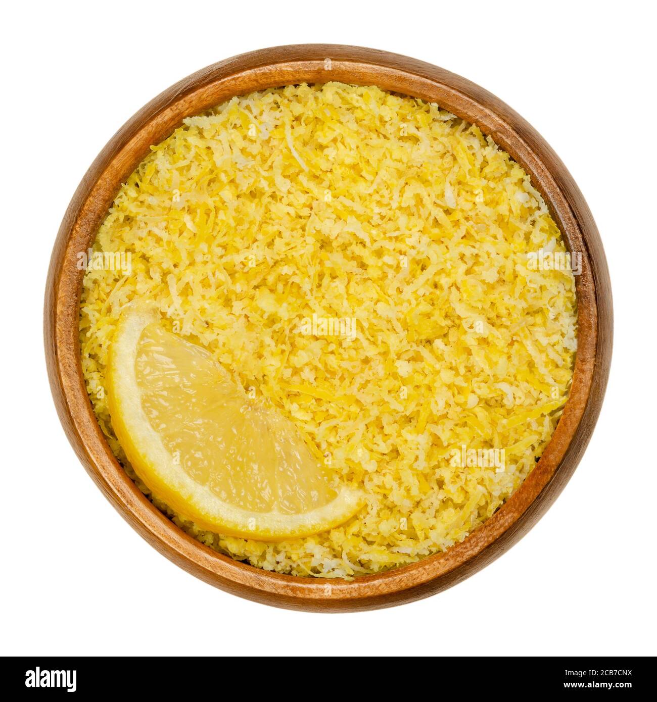 Lemon slice and freshly grated lemon peel in a wooden bowl. Zests of ripe yellow edible citrus fruits. Citrus limon. Used as flavoring for baking. Stock Photo