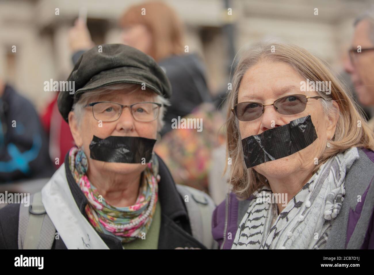 Two female members of the environmental group Extinction Rebellion seen in defiance of Section 14 Public Order Act gathering on Trafalgar Square. Stock Photo