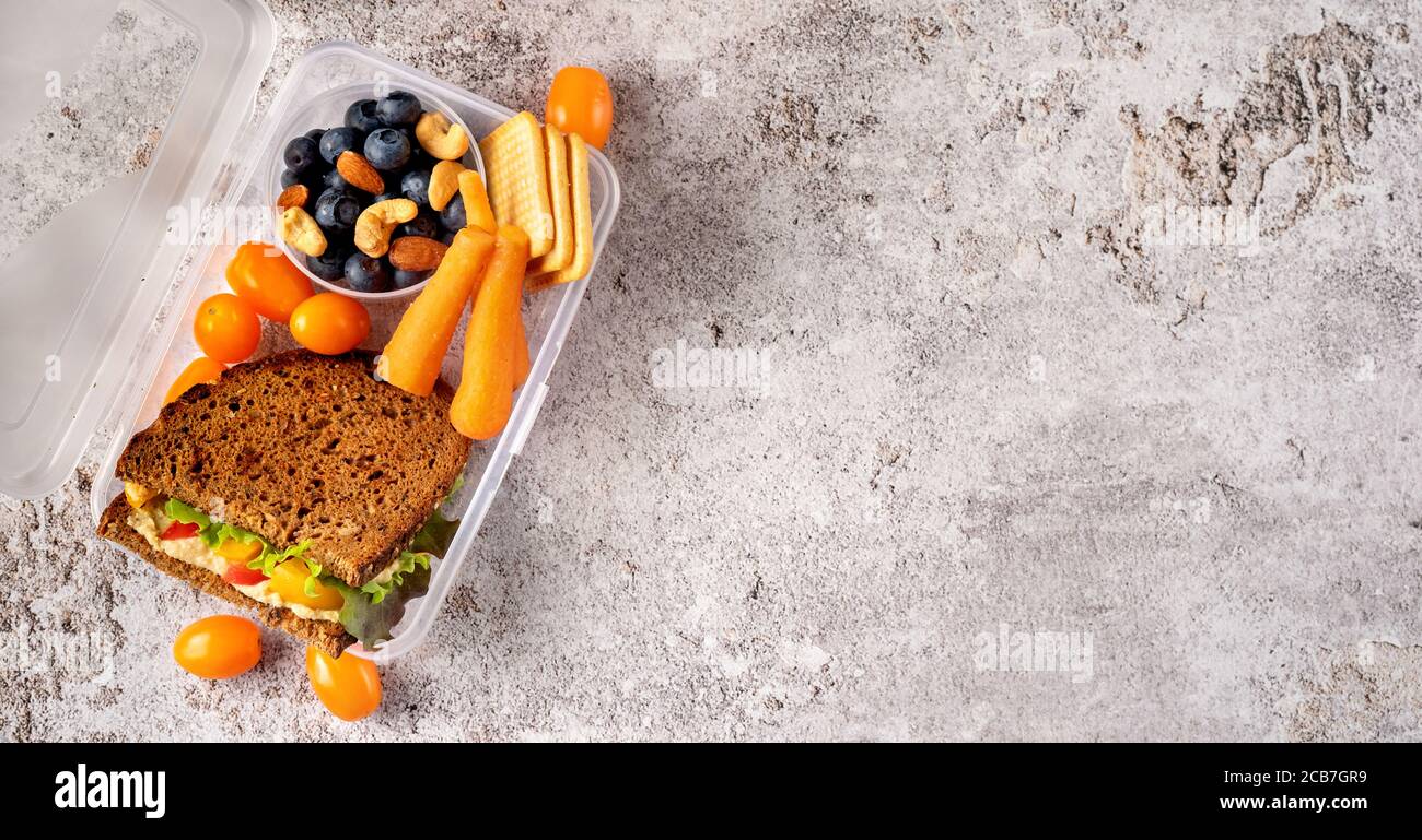 https://c8.alamy.com/comp/2CB7GR9/top-view-of-a-school-lunch-box-on-gray-concrete-background-2CB7GR9.jpg