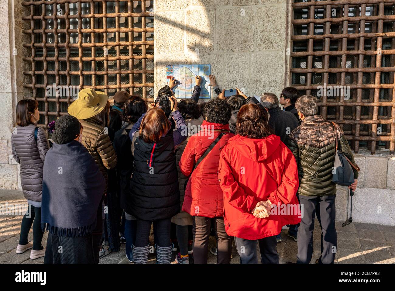 Italy, Venice, December 12 2018 Asian tourists are looking at a map of the city of Venice. Stock Photo