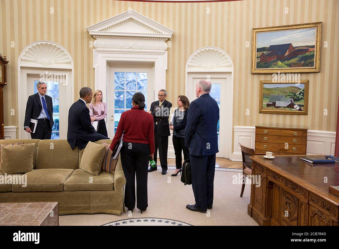 President Barack Obama talks with from left: Chief of Staff Denis McDonough; Kathryn Ruemmler Counsel to the President; National Security Advisor Susan E. Rice; John Podesta Counselor to the President; Lisa Monaco Assistant to the President for Homeland Security and Counterterrorism; and CIA Director John Brennan in the Oval Office March 19 2014. (Official White House Photo by Pete Souza) ca. 19 March 2014 Stock Photo